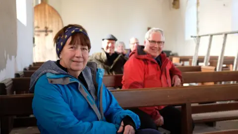 YDNPA Trustees Heather Swettenham (front), Martin Booth (second row), Ian Whinray, Rev Martin Fletcher and Annie Sumner on the pews to be turned into bunk beds