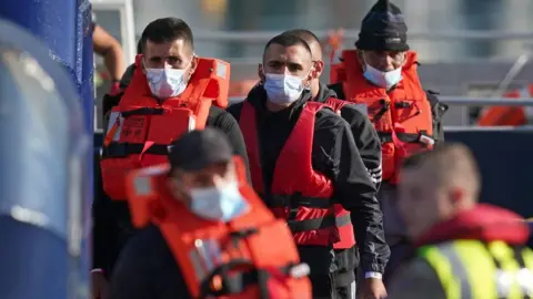 PA Media/Gareth Fuller Migrants arriving at Dover