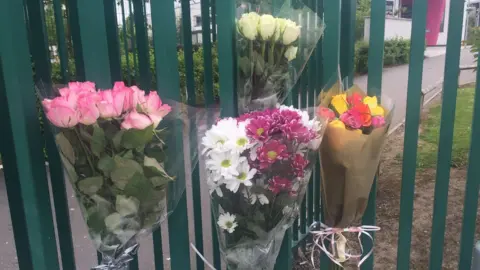 Flowers at the school gate for Megan