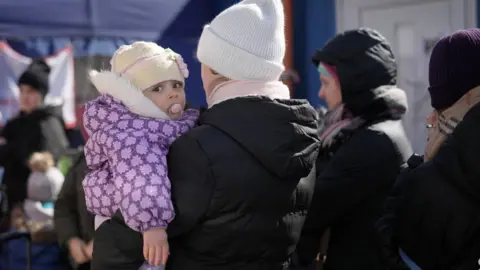 Getty Images Refugees fleeing Ukraine at a centre in Slovakia, 13 March 2022