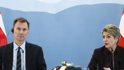 Britain's Chancellor of the Exchequer Jeremy Hunt (L) and Swiss Federal Councillor Karin Keller-Sutter (R) attend a press conference after signing of the agreement of mutual recognition in financial services for over two years between Switzerland and the United Kingdom