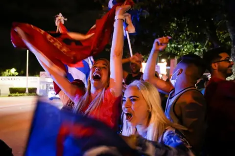 Getty Images Supporters of US President Donald Trump rally in front of Cuban restaurant Versailles in Miami, Florida on 3 November