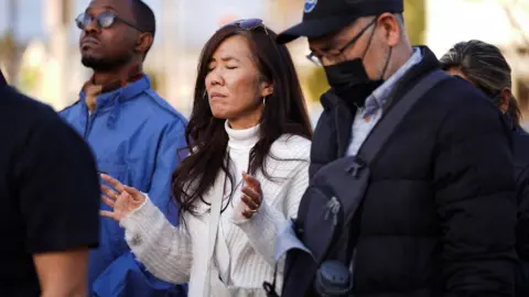 Reuters A woman holds her arms in prayer