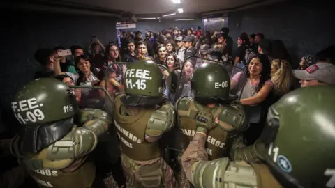 EPA Chilean Police close the access to the Los Heroes metro station in the middle of a demonstration, in Santiago