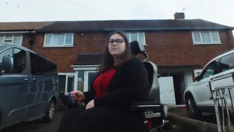 Holly Greader in front of her house