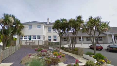 Google carehome with trees and garden in foreground