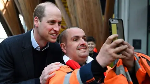 Prince William takes a selfie with a man during a visit to a homelessness project in Sheffield