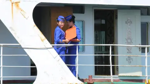 NK News Two women aboard a ship