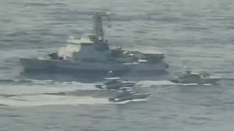 US Navy Handout photo from US Navy showing Iranian Islamic Revolutionary Guard Corps Navy (IRGCN) vessels near US vessel in the Gulf (15 April 2020)