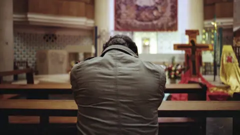 Venetia Menzies Sunny prays in the Church of Notre Dame de France, in ?????