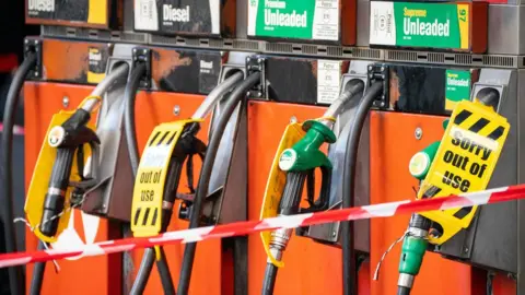 PA Media Empty petrol pumps