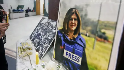 A picture of Shireen Abu Akleh at a memorial with candles