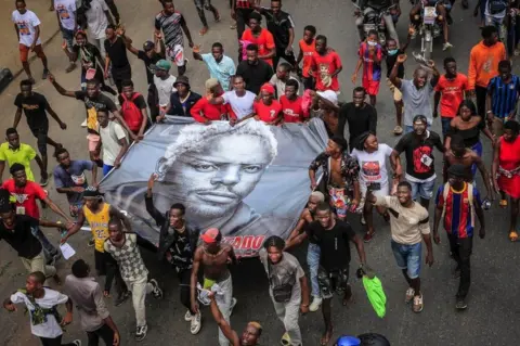 EPA People attend the procession in tribute to kuduro musician known as 'Nagrelha' in the surroundings of the city's Santa Ana cemetery, near Luanda, Angola, 22 November 2022