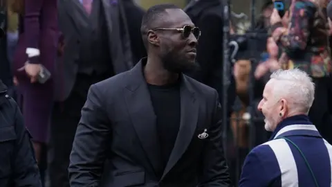PA Media Stormzy arrives for a memorial service to honour and celebrate the life of fashion designer Dame Vivienne Westwood at Southwark Cathedral, London