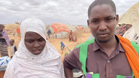 BBC/ Ed Habershon Kerad Adan and Hawa, Abdiwali's parents, outside their tent the day after their son died