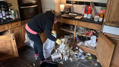 Sandra Kennelly A woman clearing out a kitchen