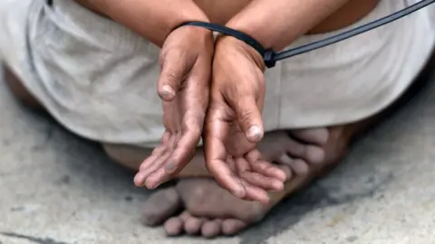 Getty Images Hands tied together