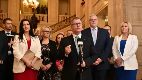 Charles McQuillan/Getty DUP leader Sir Jeffrey Donaldson (C) speaks to the media at Stormont on February 3, 2024 in Belfast, Northern Ireland. Sinn Fein's Michelle O'Neill becomes the new Northern Ireland First Minister