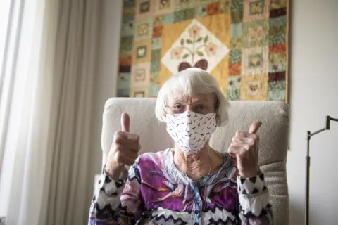 Getty Images Older woman wearing a facemask