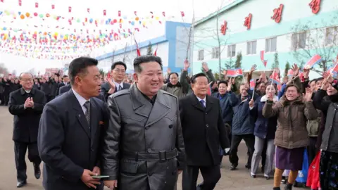 KCNA Kim Jong Un, cheered on by locals and surrounded by guards, visits a polling booth in the South Hamgyong Province for the election of delegates to the provincial, city, and county People's Assembly in a photo published by state media on 27 November