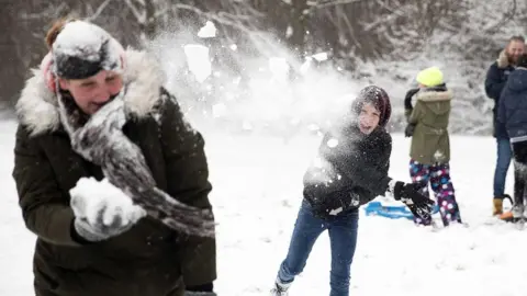 EPA People throw snowballs at each other as they enjoy the snow on a hill in Rotterdam