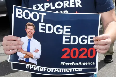 Getty Images A fan with a flyer saying 'Boot Edge Edge'