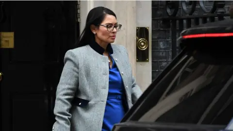 Getty Images Home Secretary Priti Patel insists quarantine will help stop the virus' spread