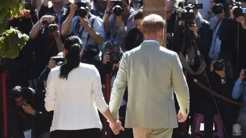 EPA Harry and Meghan being met by the press