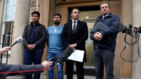 PA Media Gordon Arthur (right) with former cricketers Majid Haq (left) and Qasim Sheikh (second left) and lawyer Aamer Anwar earlier this month