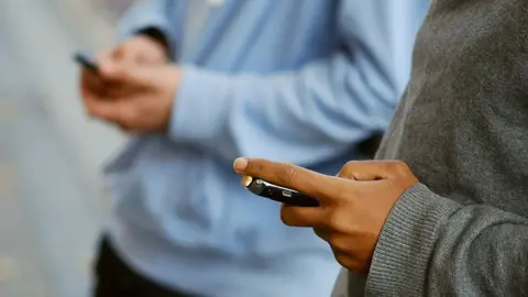 Getty Images Students texting