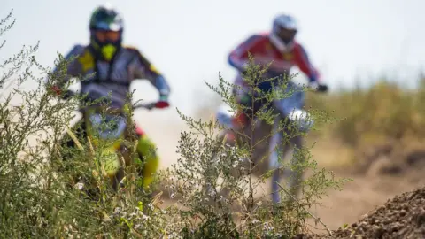 Getty Images Blurry image of motorcycles during the motocross race
