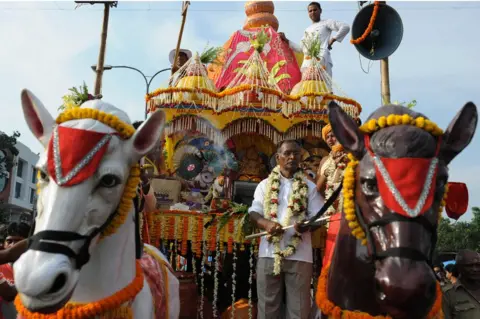 Getty Images Indian devotees and members of the International Society for Krishna Consciousness (ISKCON) march alongside a chariot carrying a deity during the annual Rath Yatra Festival in Siliguri on June 24, 2009.