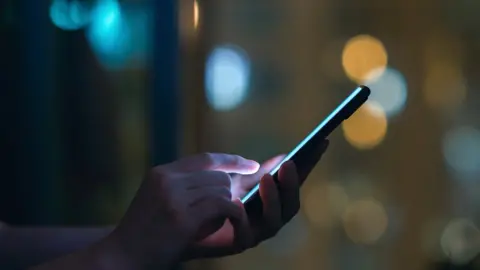 Getty Images A phone hand and a phone