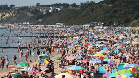 PA/Andrew Matthews Crowds flocked to Bournemouth beach in Dorset