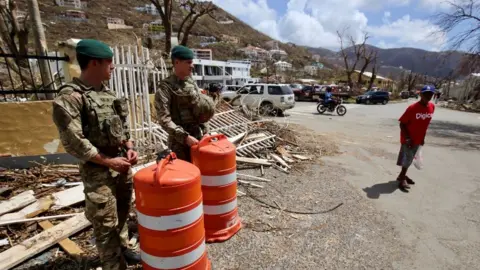 Paul Blake/BBC Troops on the streets of Tortula