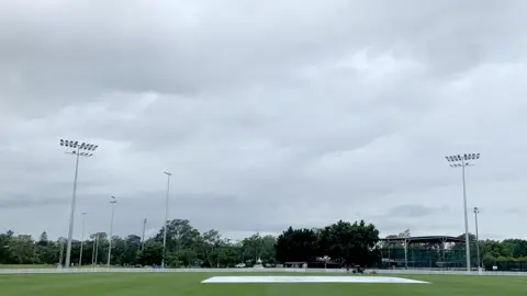 Covers are seen on the pitch as play is abandoned due to wet weather on day one of the England intra-squad Ashes Tour match between England and the England Lions at Ian Healy Oval