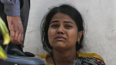 Sumit Kumar A woman crying outside a crematorium