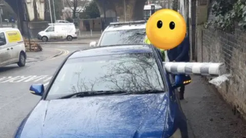 @roadpolicebch Car with a roll of vinyl flooring sticking out