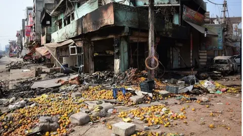 Getty Images Burnt shops following clashes between supporters and opposers of the contentious amendment to India's citizenship law.