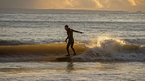 Phil Rees/REX/Shutterstock Surfer