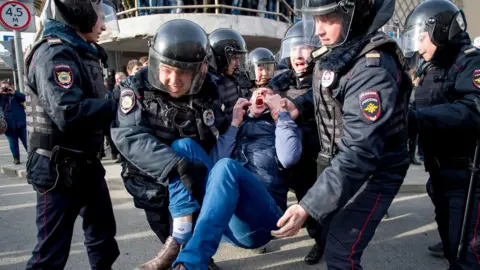 ALEXANDER UTKIN A protester is held by police during an anti-corruption rally in Moscow in March 2016.