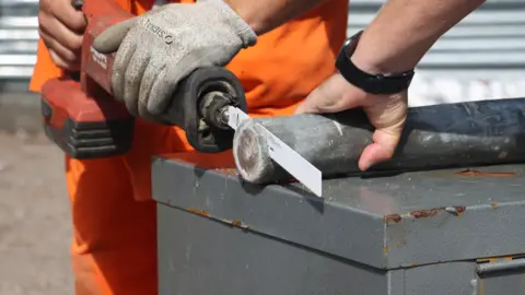 University of Portsmouth A metal pipe being sawn open