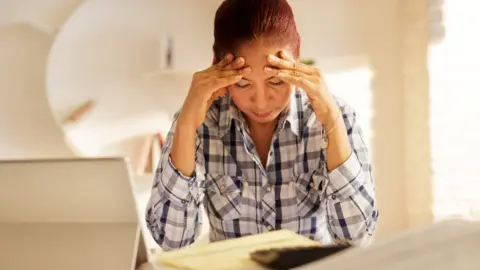 Getty Images Distressed woman filling in form (file image)