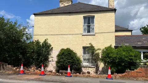 Richard Knights/BBC A house wall hit by a bus in Bicknacre