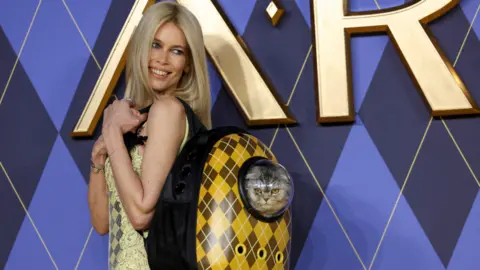Reuters Claudia Schiffer carries a cat as she attends the premiere of "Argylle" at Leicester Square in London, Britain, January 24, 2024.