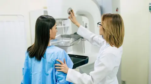 Getty Images A doctor speaks to a woman during a screening for breast cancer