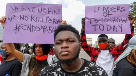 Reuters Demonstrators hold banners during a protest against alleged police brutality, in Lagos, Nigeria