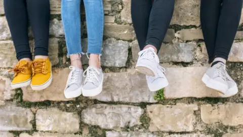 Getty Images Feet of young people