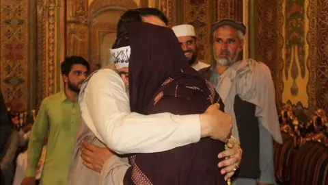 Hayatullah Hayat/Facebook Hayatullah Hayat hugs a member of the Taliban during the June 2018 ceasefire