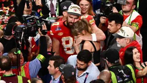 Getty Images American singer-songwriter Taylor Swift and Kansas City Chiefs tight end #87 Travis Kelce hug after the Chiefs won Super Bowl LVIII against the San Francisco 49ers at Allegiant Stadium in Las Vegas, Nevada, on February 11, 2024.
